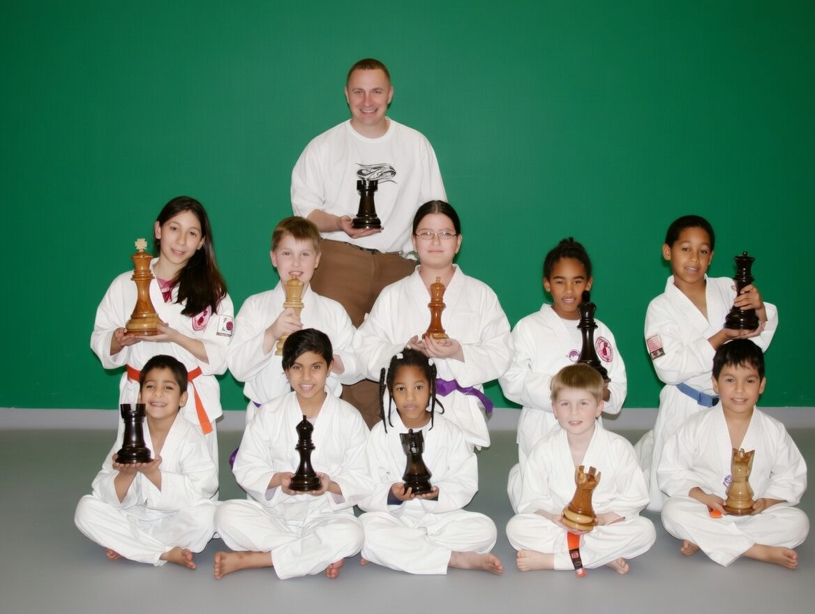 Thumbnail for 12-inch Teak Giant Chess winners proudly displaying their trophies after a successful tournament.